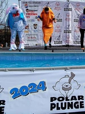 Me and sister jumping for the polar plunge with our team